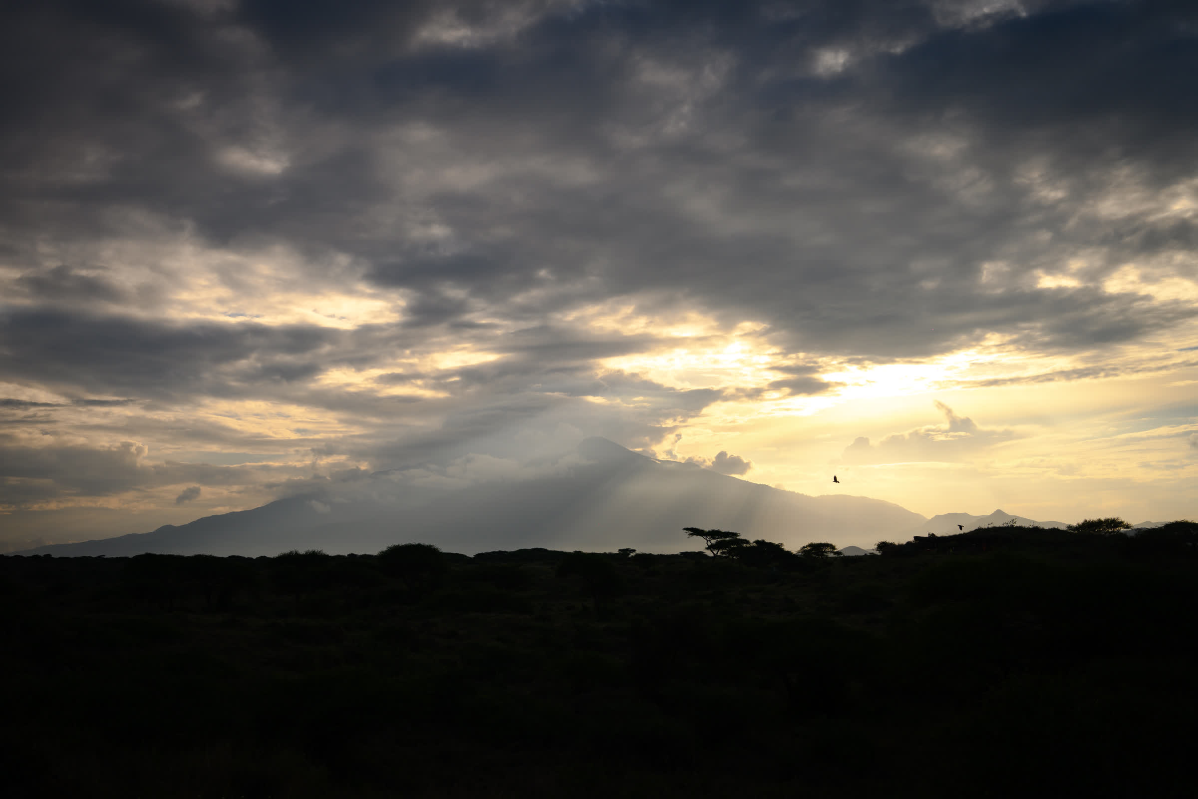 Light breaking through cloud over the plain at dusk
